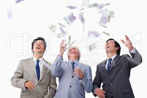 Bank notes raining down on businessteam