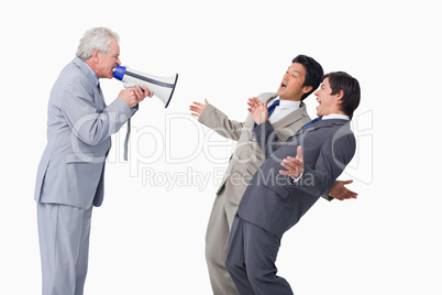 Senior salesman with megaphone yelling at his employees