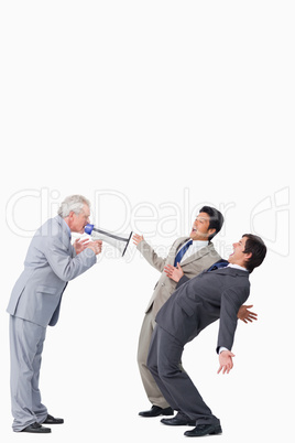 Mature salesman with megaphone yelling at his employees