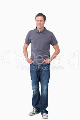 Smiling young man with hands in his pockets