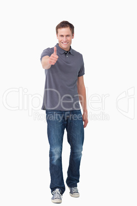 Smiling young man giving thumb up