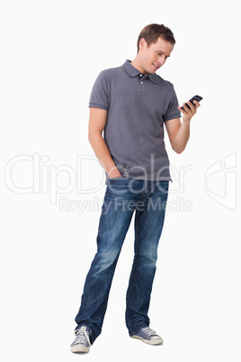 Young man typing text message on his cellphone