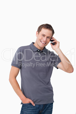 Smiling young man on his mobile phone