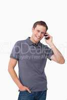 Smiling young man on his mobile phone