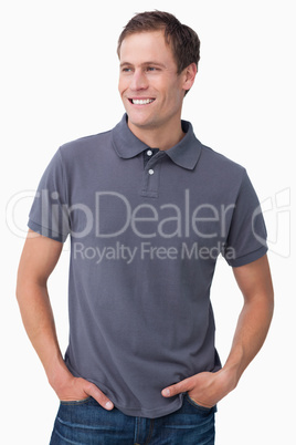 Smiling male with hands in his pockets