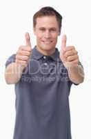 Thumbs up given by smiling young man