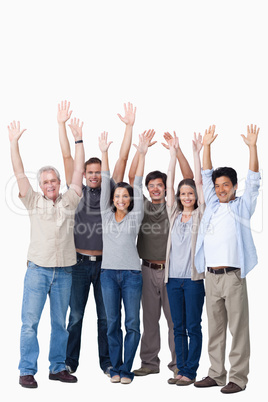 Cheering group of friends raising their arms