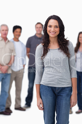 Smiling young woman with friends standing behind her
