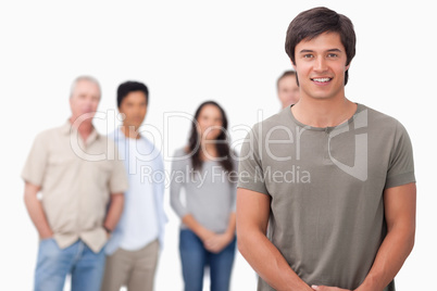 Smiling male with friends behind him