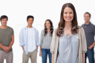 Smiling woman with friends standing behind her