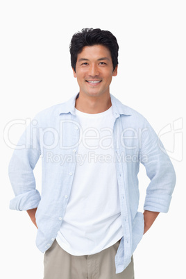 Smiling man with hands in his pockets Smiling man with hands in his pockets