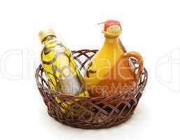 Bottle and jar of virgin olive oil in basket
