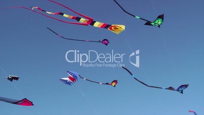 Kites flying against blue sky