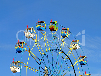 Color carousel against of the summer blue sky.