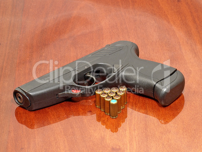 Black pistol and gas cartridges.