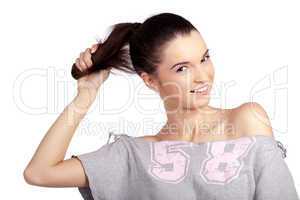 Happy young girl pulling her healthy ponytail