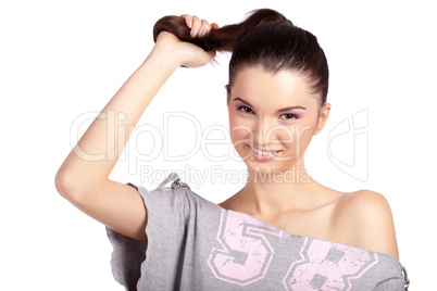Young girl pulling her hair and smiling