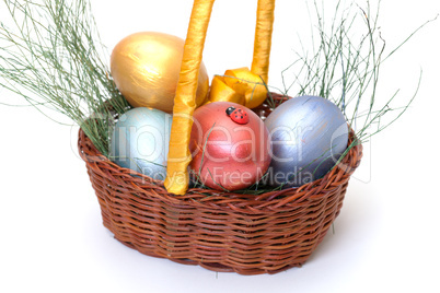 Colorful painted easter eggs in basket