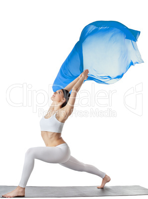 woman doing yoga asana with blue flying fabric