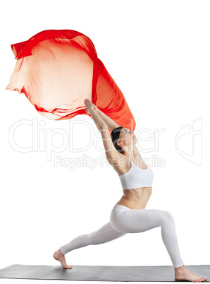 woman in yoga pose and red flying fabric