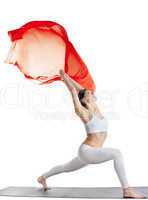 woman in yoga pose and red flying fabric