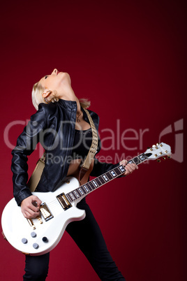 rock woman in passion play on guitar