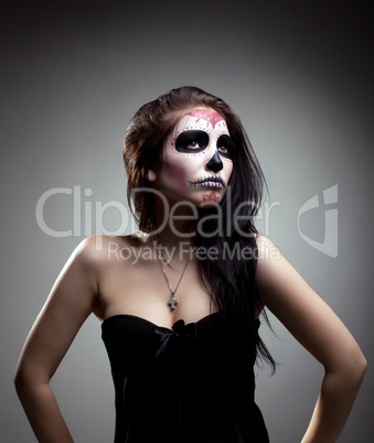 Young woman in day of the dead mask skull face art