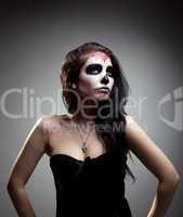 Young woman in day of the dead mask skull face art