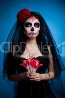 Serious woman in skull face art mask and flowers