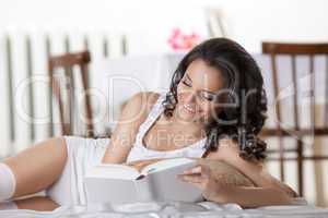young woman read book in morning interior smile