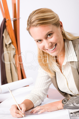 Architect woman sketches office with blueprint