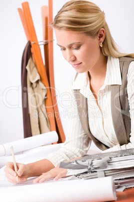 Architect woman sketches office with blueprint