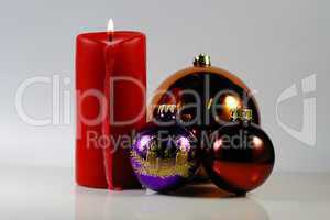 red candle with christmas tree ball