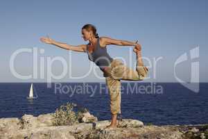 Yoga exercise on a rock
