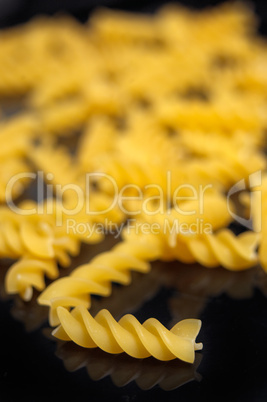 Italian pasta fusilli over black