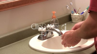 Washing hands in sink; 2