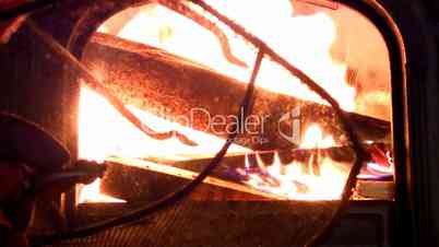 Tending fire in wood stove