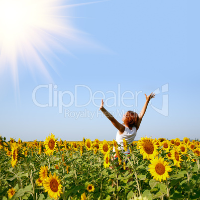 redhaired woman in sunflower field