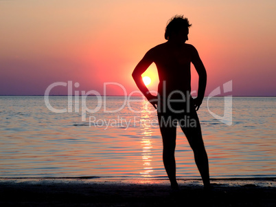 A black silhouette of a young guy on a sunset 2