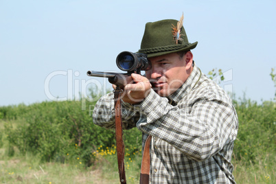 hunter with rifle ready for shot