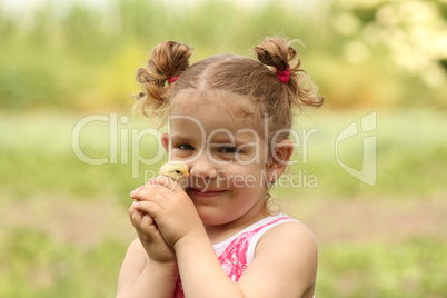 young girl holding little chicken