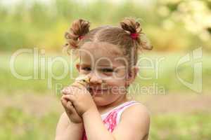 young girl holding little chicken