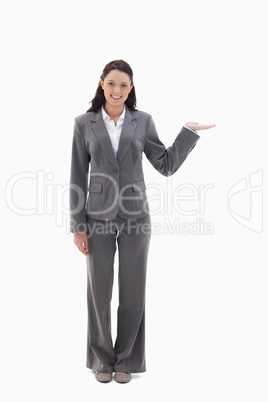 Smiling businesswoman and presenting a product