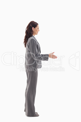 Profile of businesswoman shaking hands
