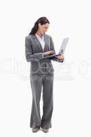 Businesswoman smiling while watching her laptop