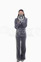 Expressive businesswoman speaking in a megaphone