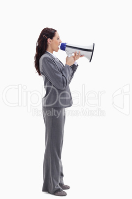 Profile of a businesswoman speaking loudly in a megaphone