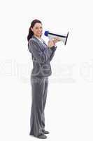 Profile of a businesswoman smiling with a megaphone