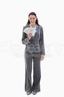 Businesswoman smiling with a lot of bank notes in her hand