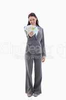 Happy businesswoman with a lot of bank notes in her hand